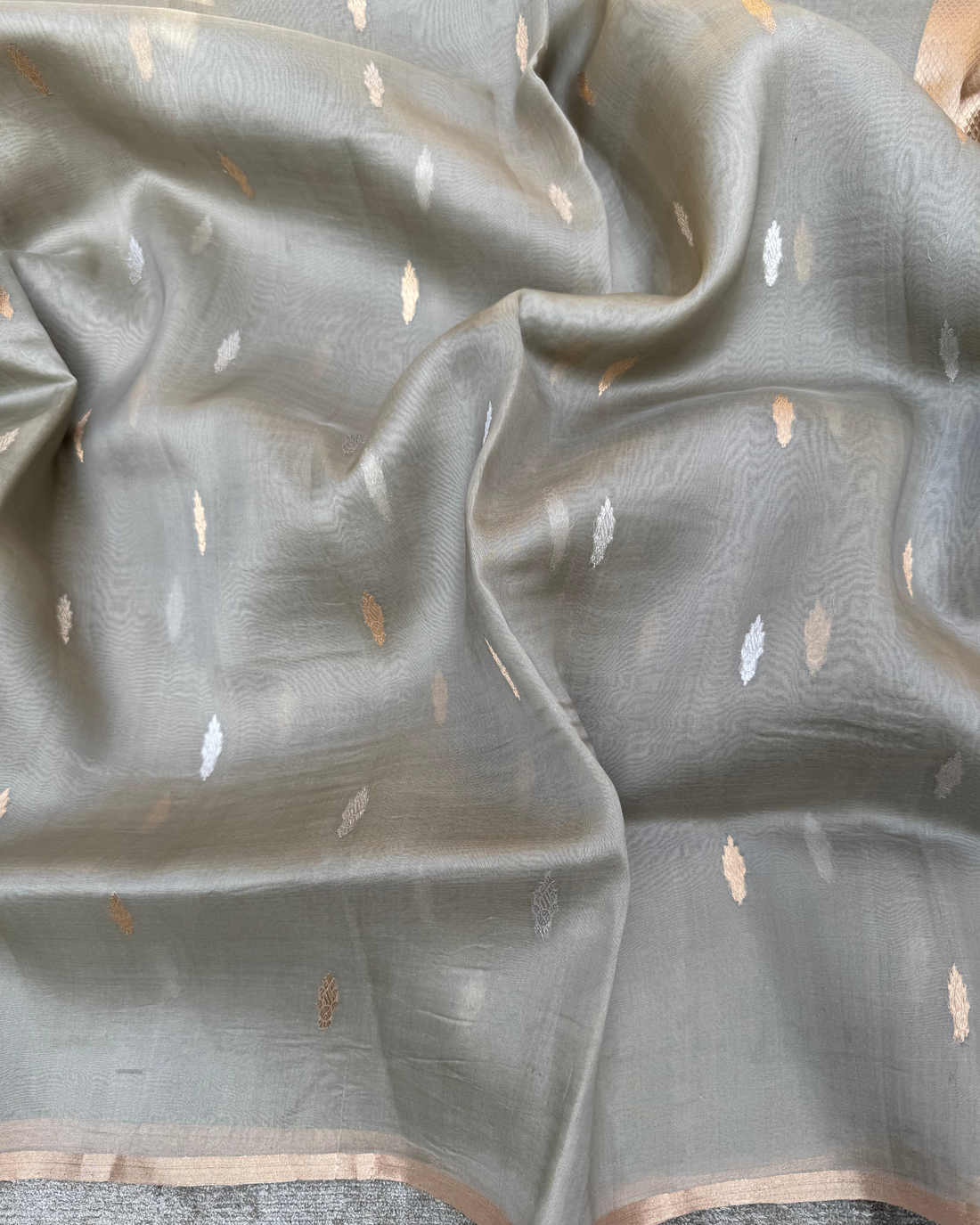 Sheer lightweight drape and pleats view of grey pure Kora silk Banarasi saree