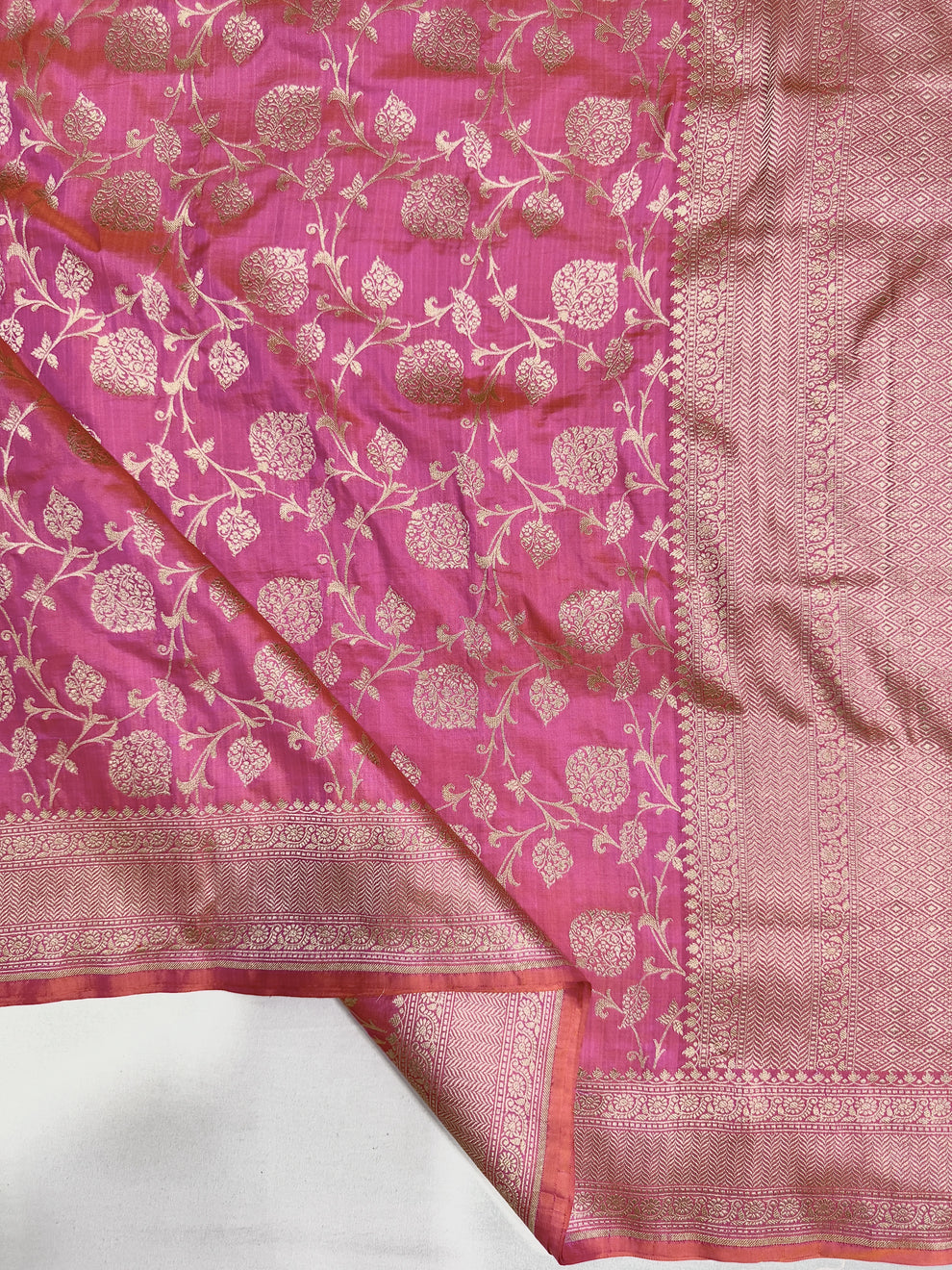 Richly woven geometric zari pallu on rani pink Pick & Pick Banarasi saree