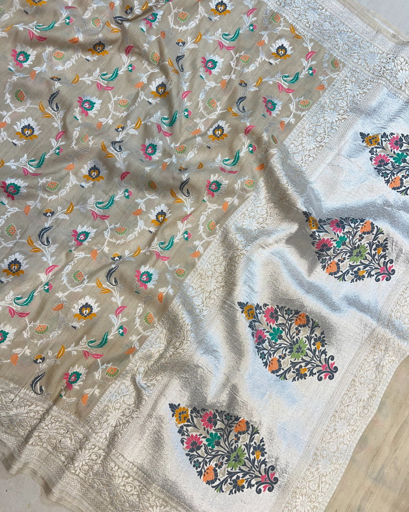 Pallu view of ash white tissue Tussar Georgette saree with silver zari border