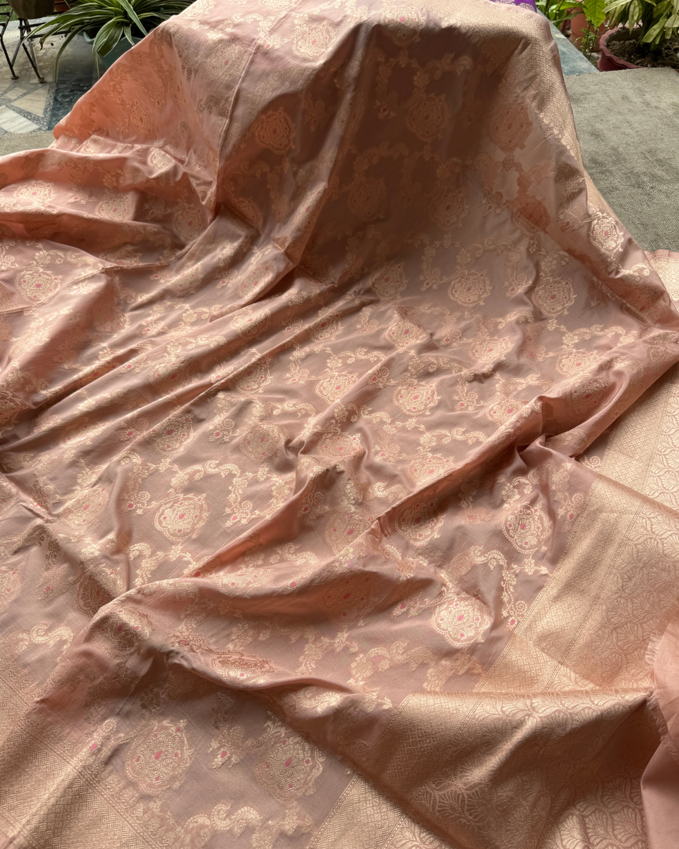 Close-up of large golden zari floral motifs in Kadhua weave on dusty peach saree