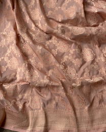 Draped pleats showing subtle luster of dusty peach Banarasi Katan silk saree