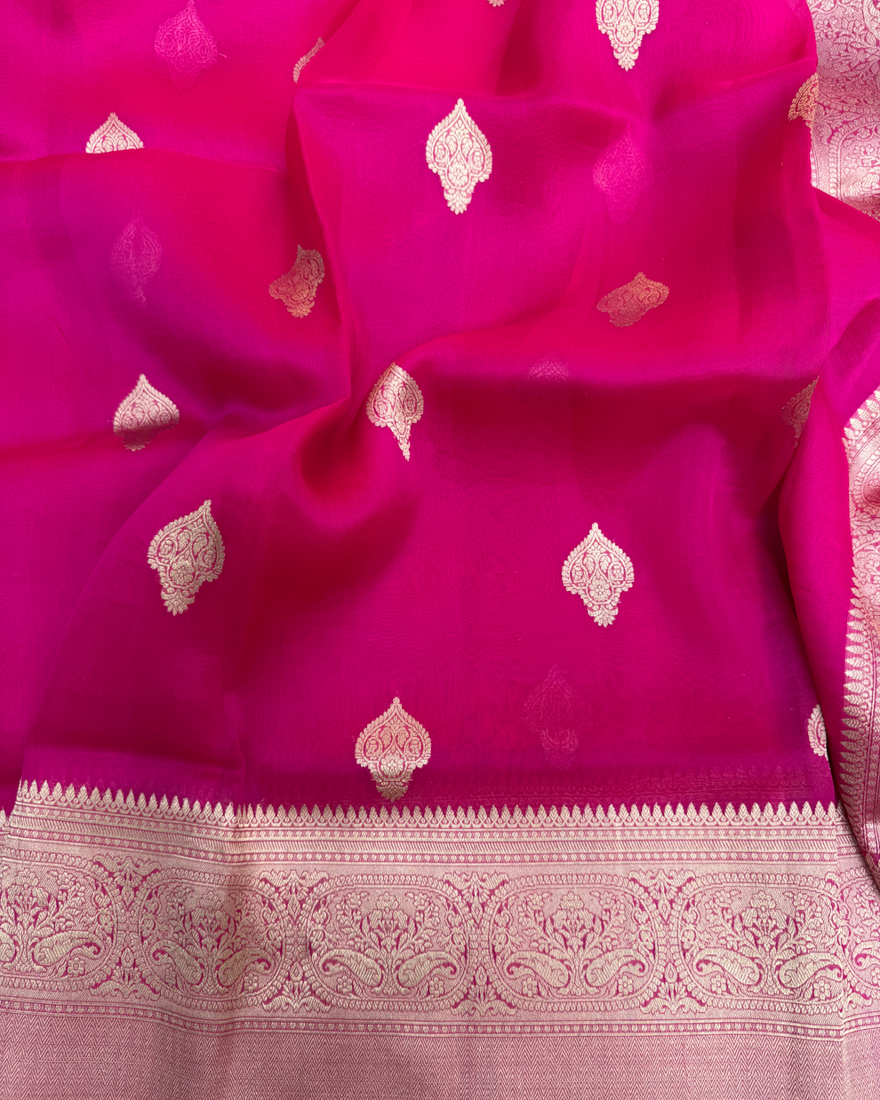 Close-up of handwoven Kadwa floral boota on red pure Kora silk Banarasi saree