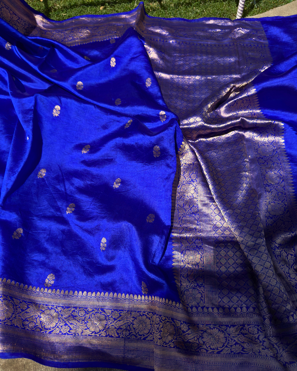 Close-up of dual-tone metallic zari work on dark blue Mulberry silk saree