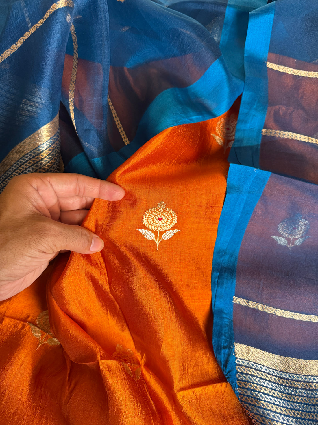 Intricate Meenakari and gold zari buttas on vibrant Kesariya orange Katan silk kurta
