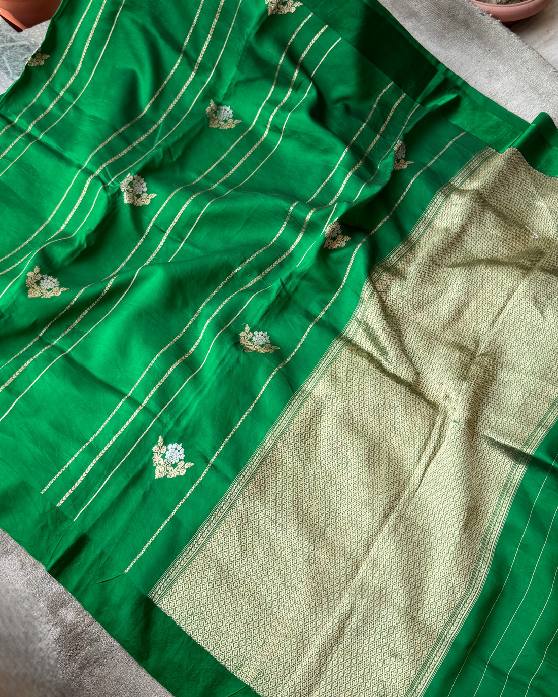 Delicate body motifs on green handloom Mulberry soft silk saree