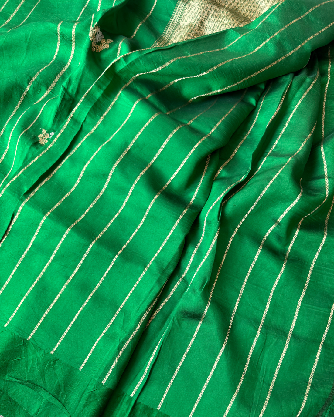 Neatly folded green pure Mulberry soft silk handloom saree