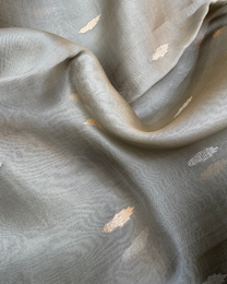 Close-up of handwoven Kadwa rose boota motifs on grey pure Kora silk saree