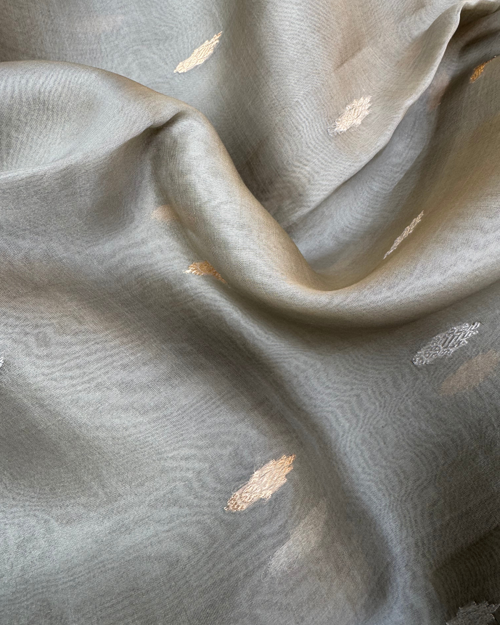 Close-up of handwoven Kadwa rose boota motifs on grey pure Kora silk saree