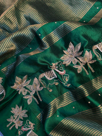 Kamdhenu and lotus motif border in hand Zardozi on emerald green pure silk saree