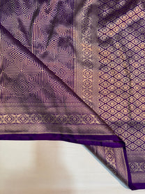 Geometric gold zari motifs in handloom Kadwa weave on purple Katan saree