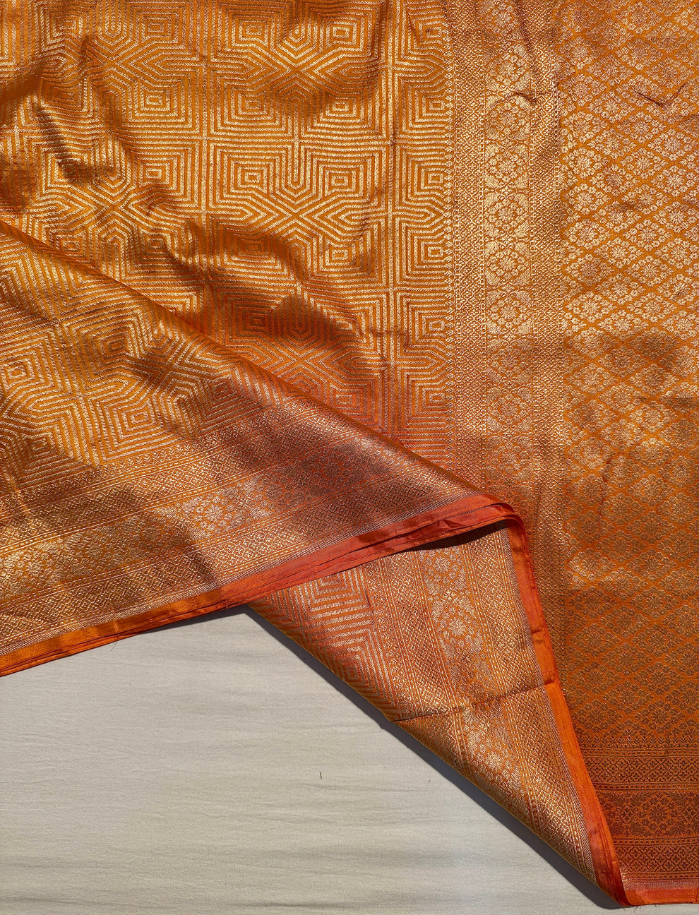 Traditional Banarasi zari border on mustard Katan silk saree detail