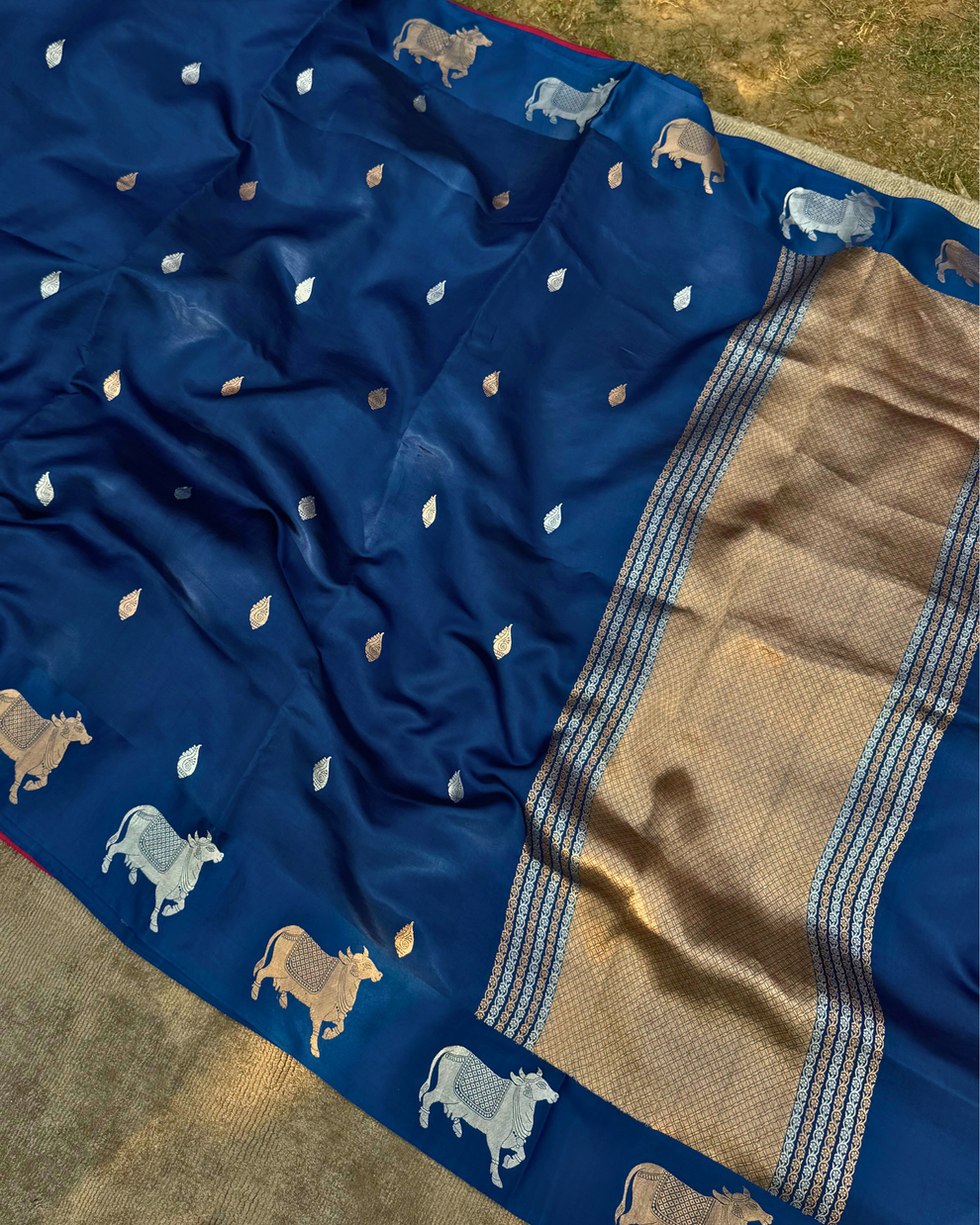 Intricate cow motif border and pallu of deep sea blue Mulberry soft silk saree