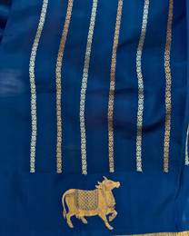 Full view of deep sea blue pure Mulberry soft silk saree with cow motif border