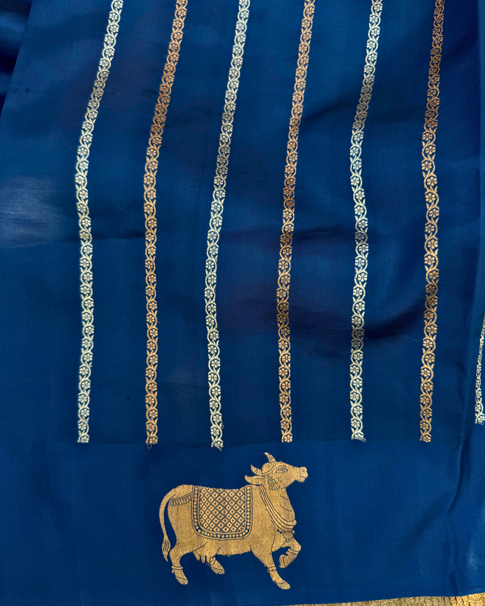 Full view of deep sea blue pure Mulberry soft silk saree with cow motif border
