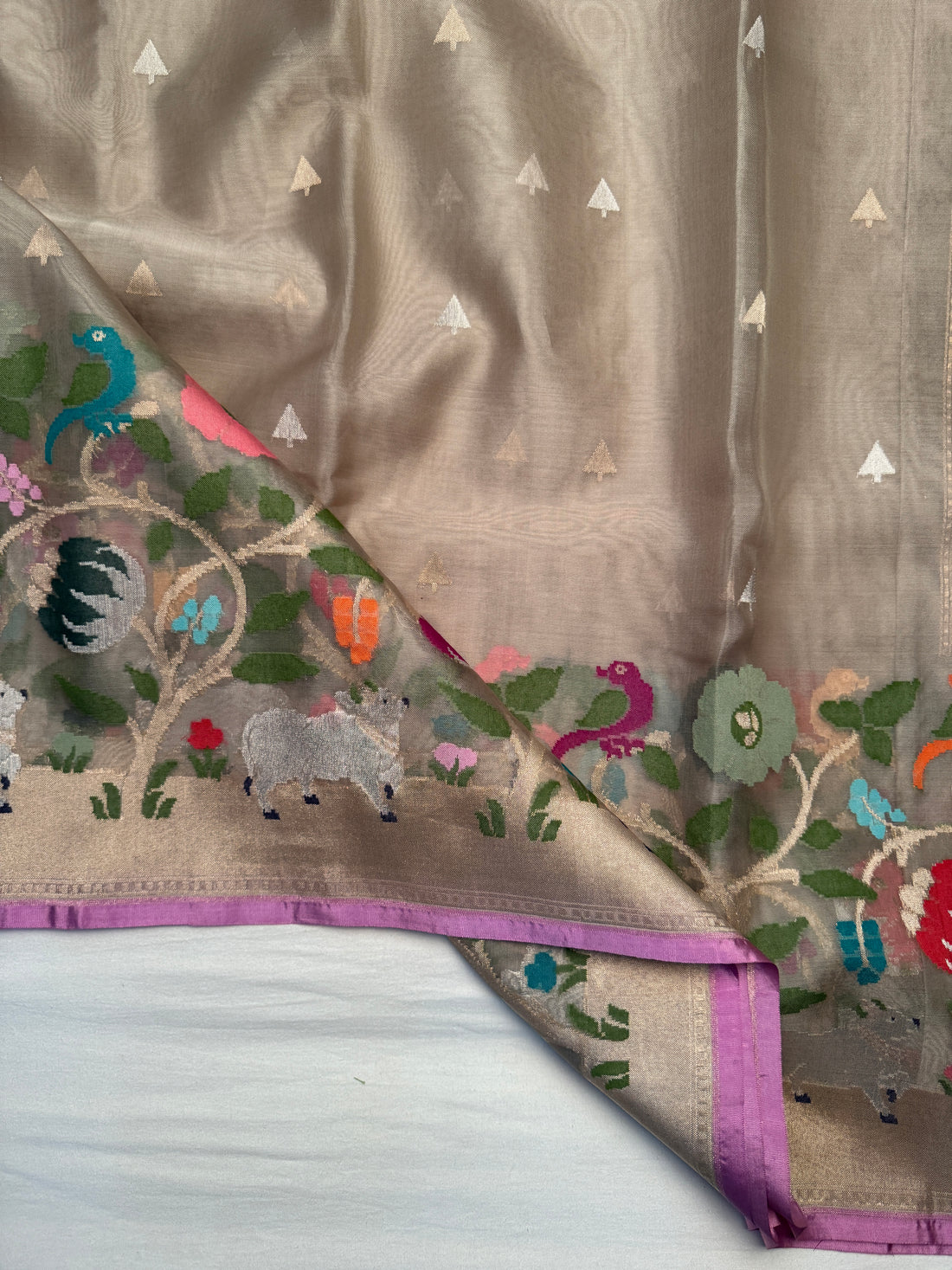 Close-up of gold zari triangular motifs on sheer Kora Jamdani saree body