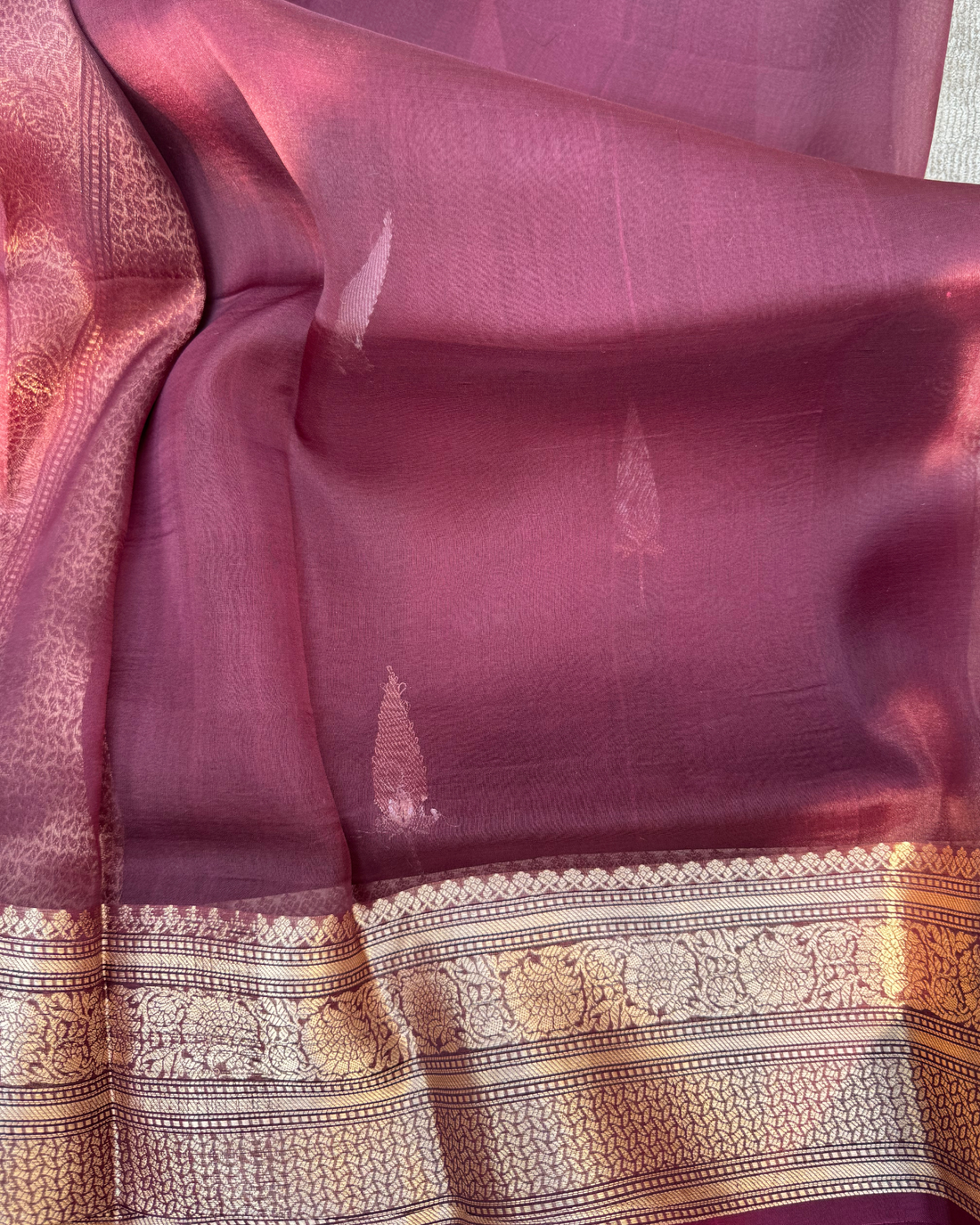 Close-up of gleaming zari Kadwa motifs on magenta pink pure Kora silk saree