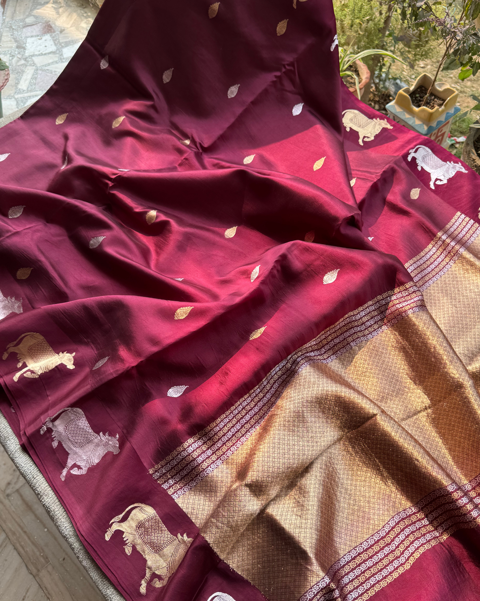 Cow motif border detailing on wine pure Mulberry soft silk saree