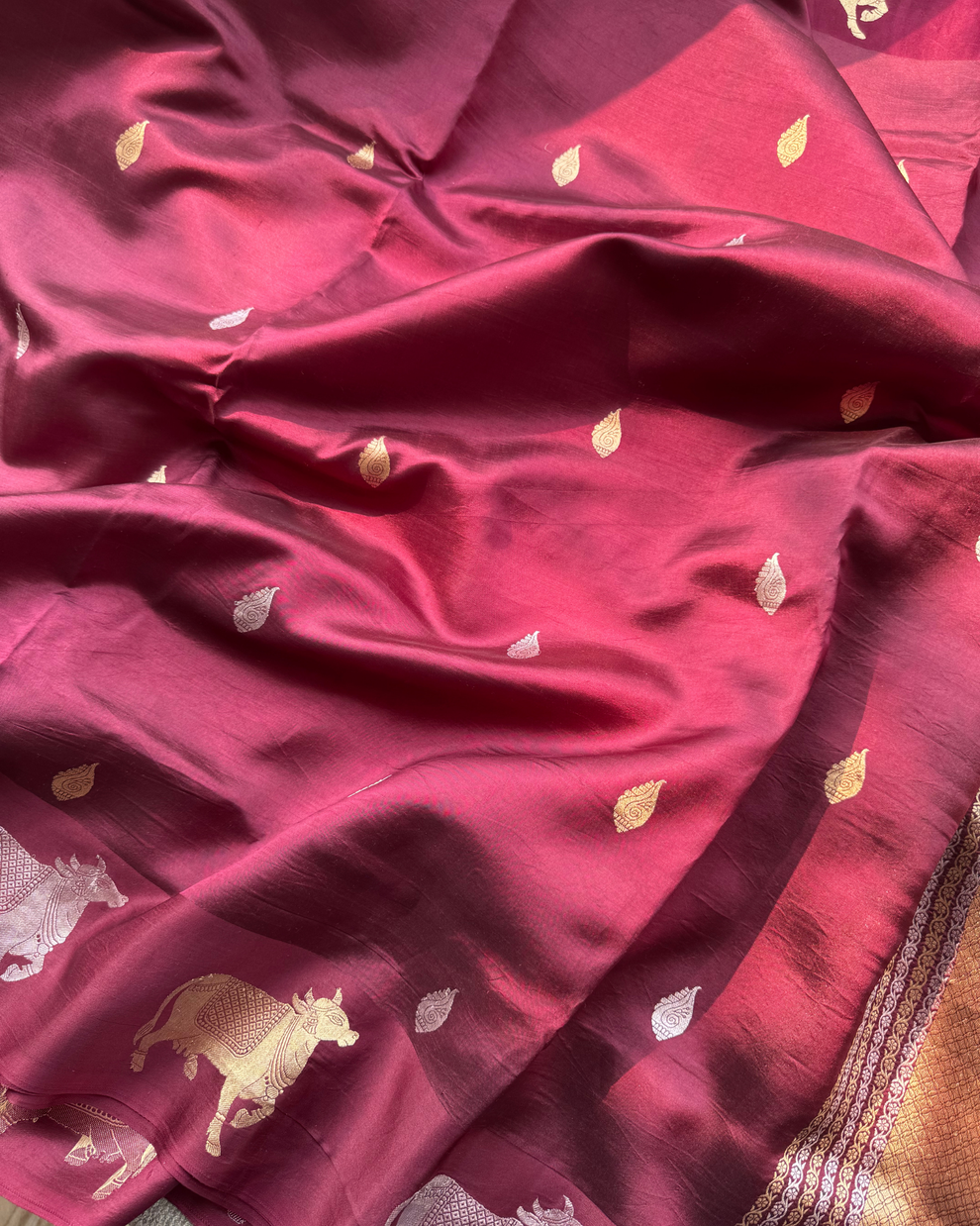Woven pallu and cow motif border on wine pure Mulberry soft silk saree
