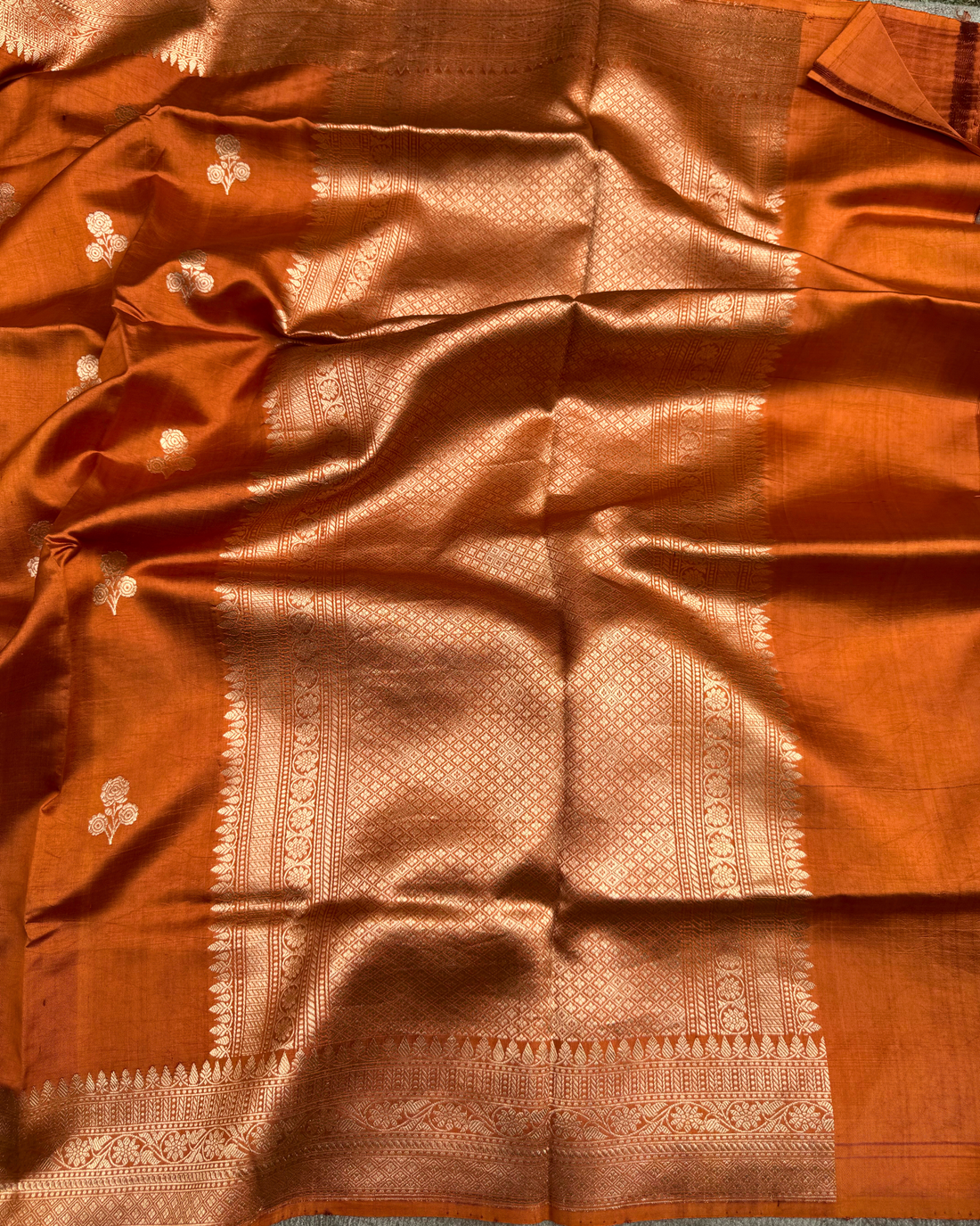 Border and pallu detailing of dusty orange pure Mulberry soft silk saree