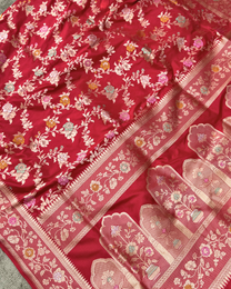 Close-up of dense traditional floral Jangla jaal on red pure Katan silk
