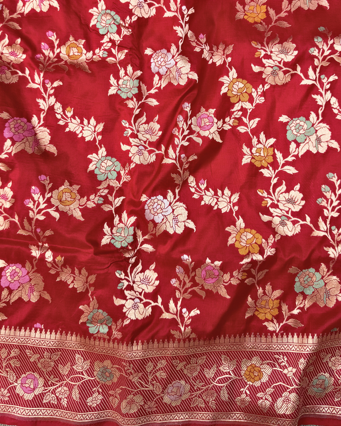 Radiant zari border and intricate motifs on red bridal Banarasi saree