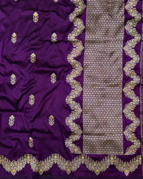 Intricate silver accent detailing on purple handloom silk saree