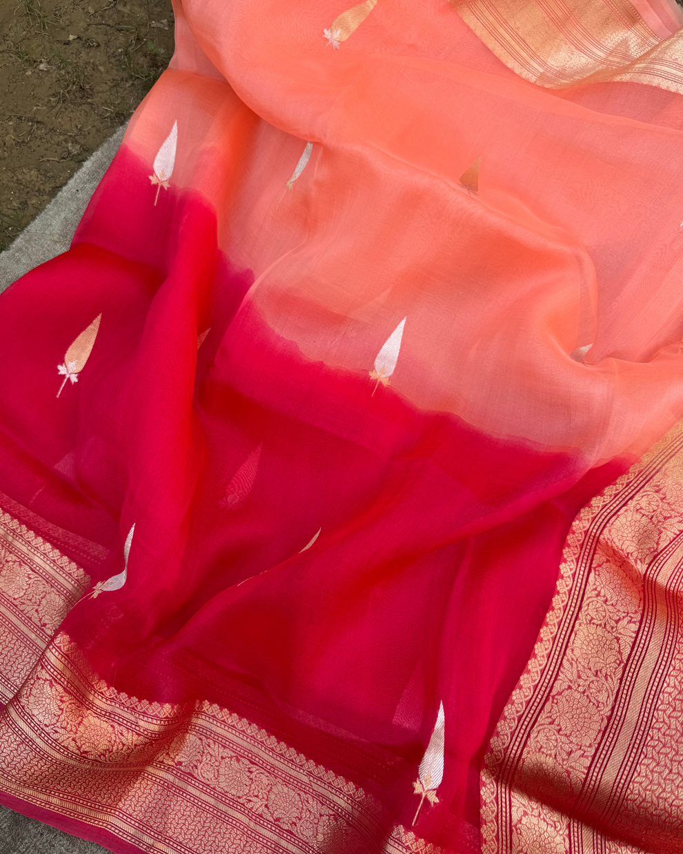 Close-up of intricate Kadwa zari motifs on peach and red pure Kora silk saree