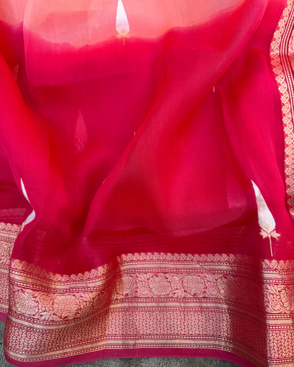 Zari border and pallu detail on red and peach pure Kora silk Banarasi saree