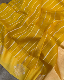 Close-up of radiant yellow handwoven Kora silk with intricate Kadwa booties