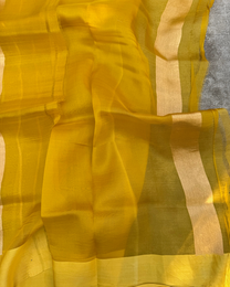 Full drape view of bright yellow sheer Kora silk saree handcrafted in Banaras