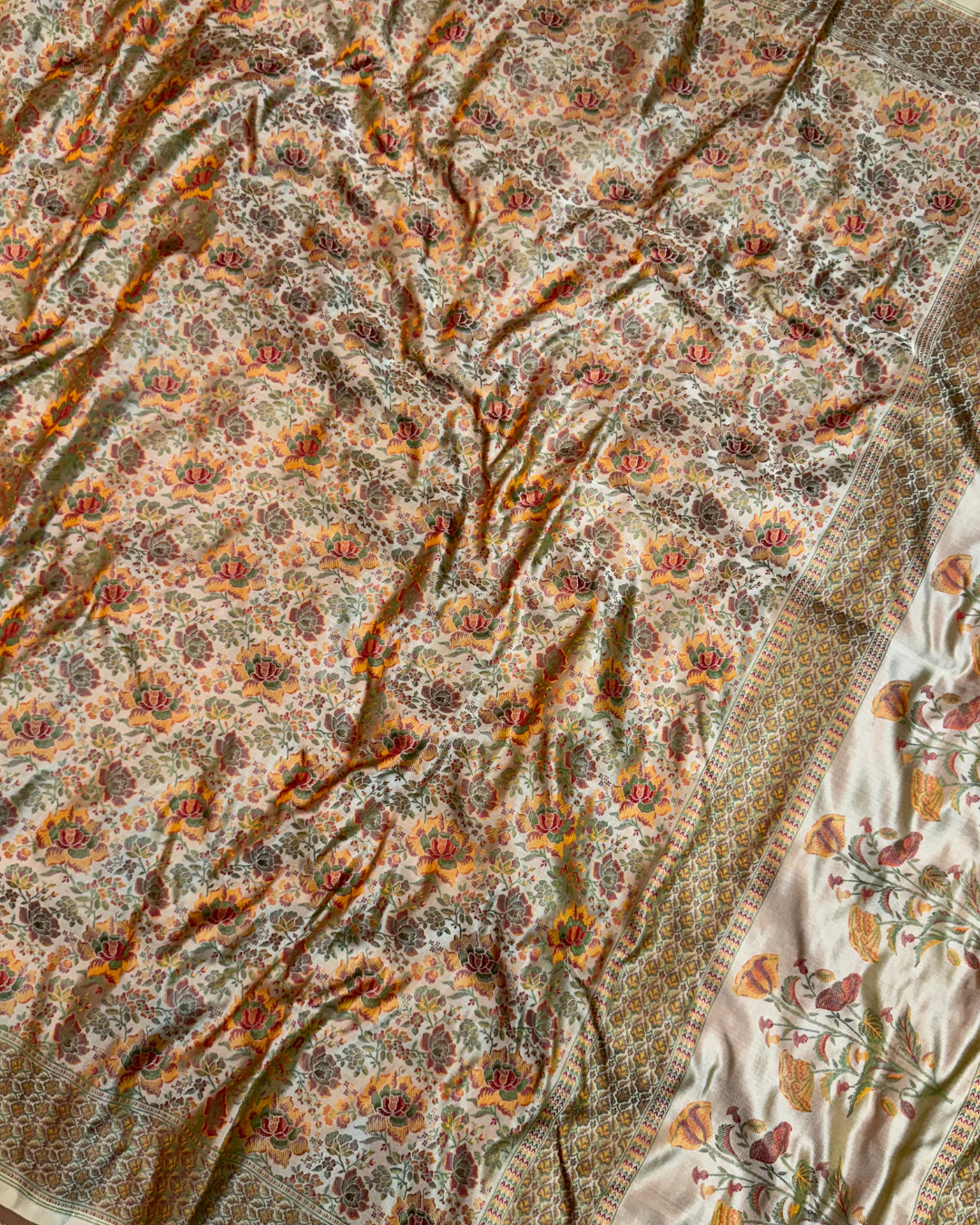 Close-up of intricate jacquard weave patterns on Jamawar Tanchui silk