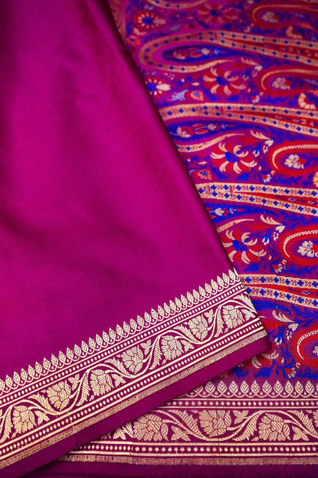 Close-up of smooth silk texture and traditional detailing on pink Mashru saree